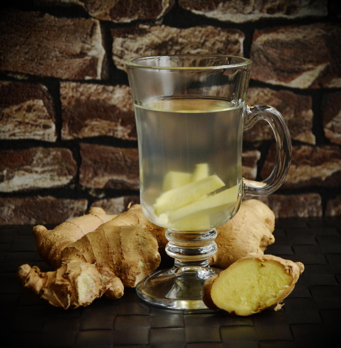 ginger tea in a glass with ginger tubers