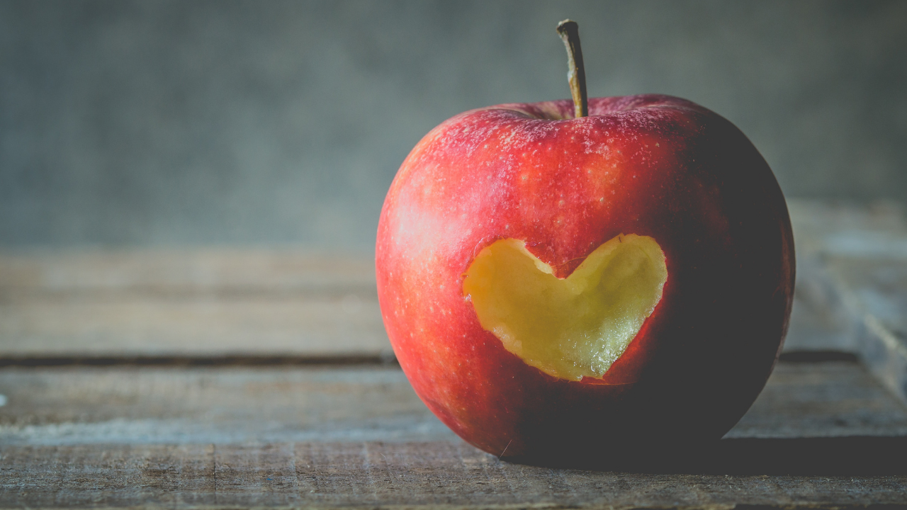 Apple with a heart bitten out of it